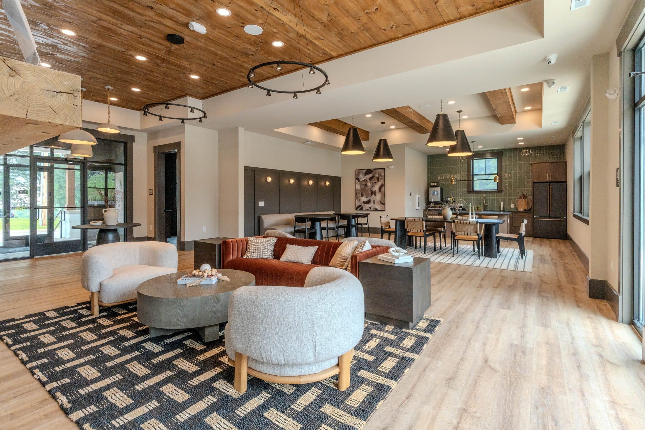 Clubhouse lounge opening to community kitchen and dining