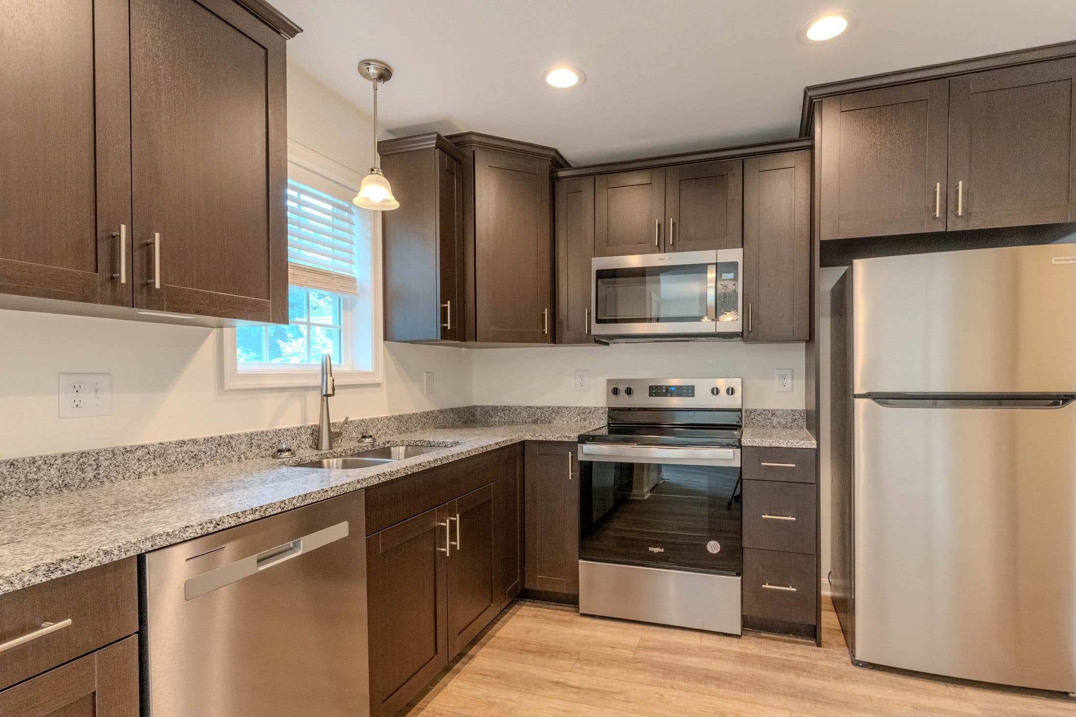 New unit kitchen with stainless appliances and granite counters
