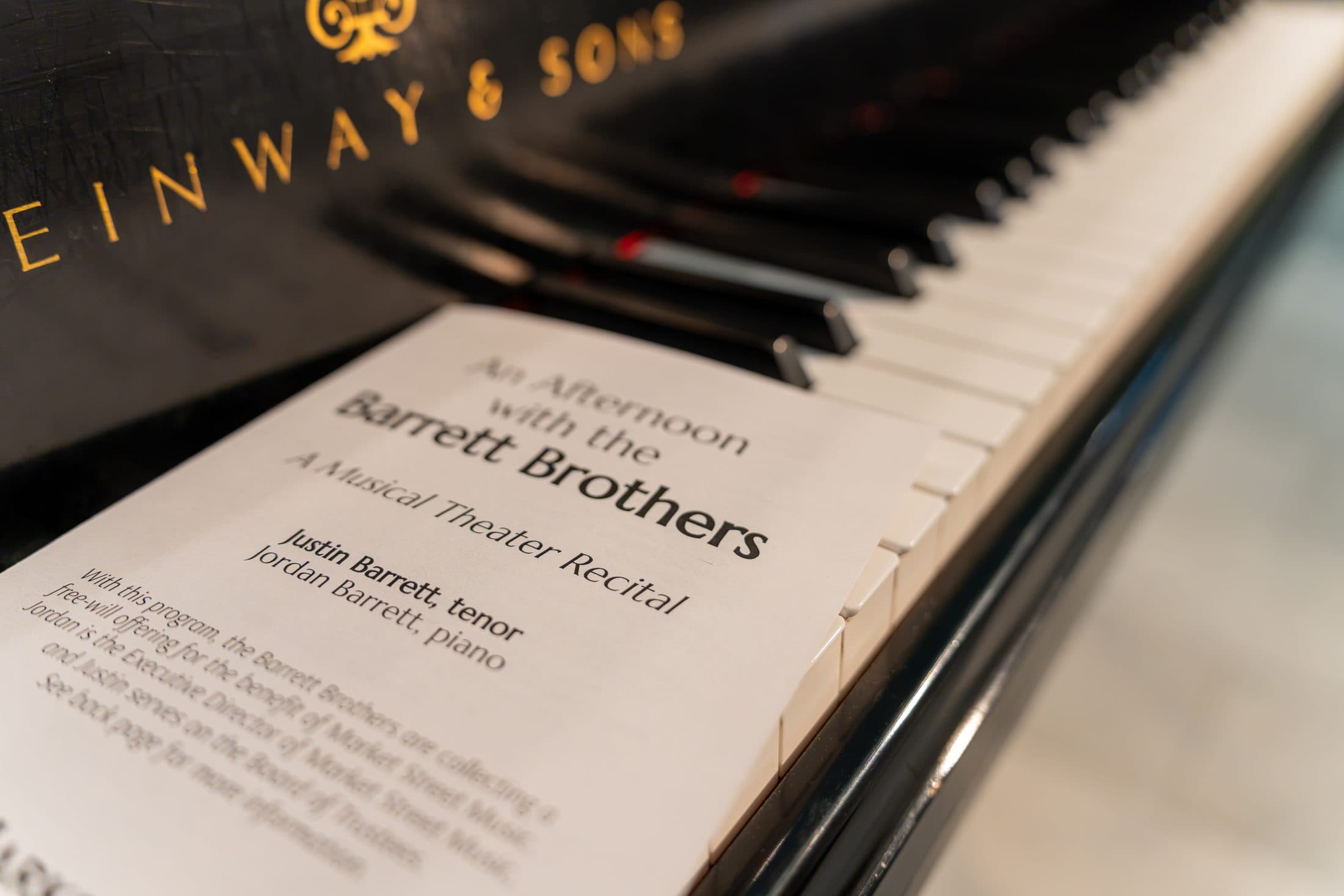 Recital program resting on the keys of a Steinway grand piano
